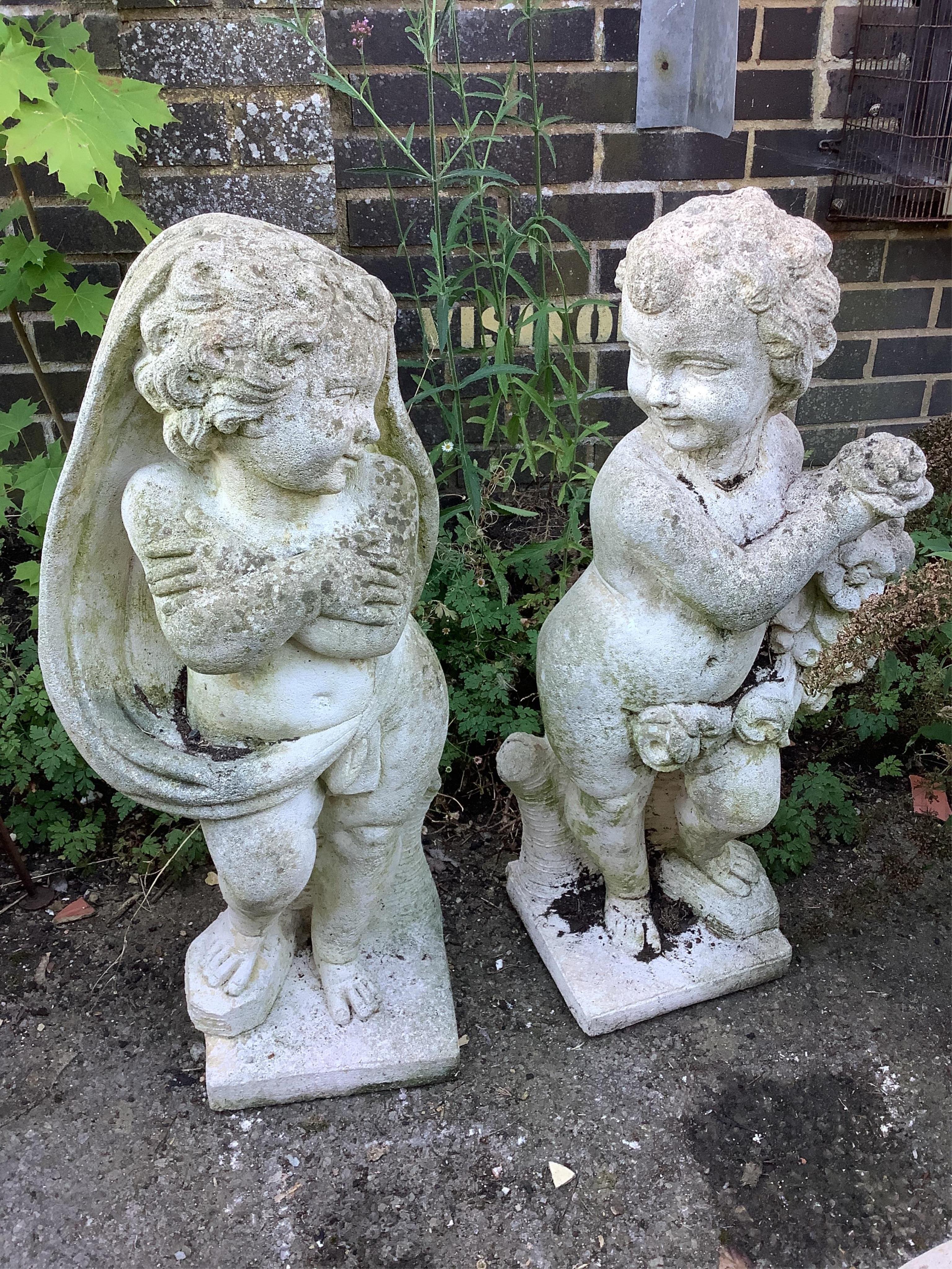 A pair of reconstituted stone putti garden ornaments, emblematic of the seasons, larger height 79cm. Condition - fair